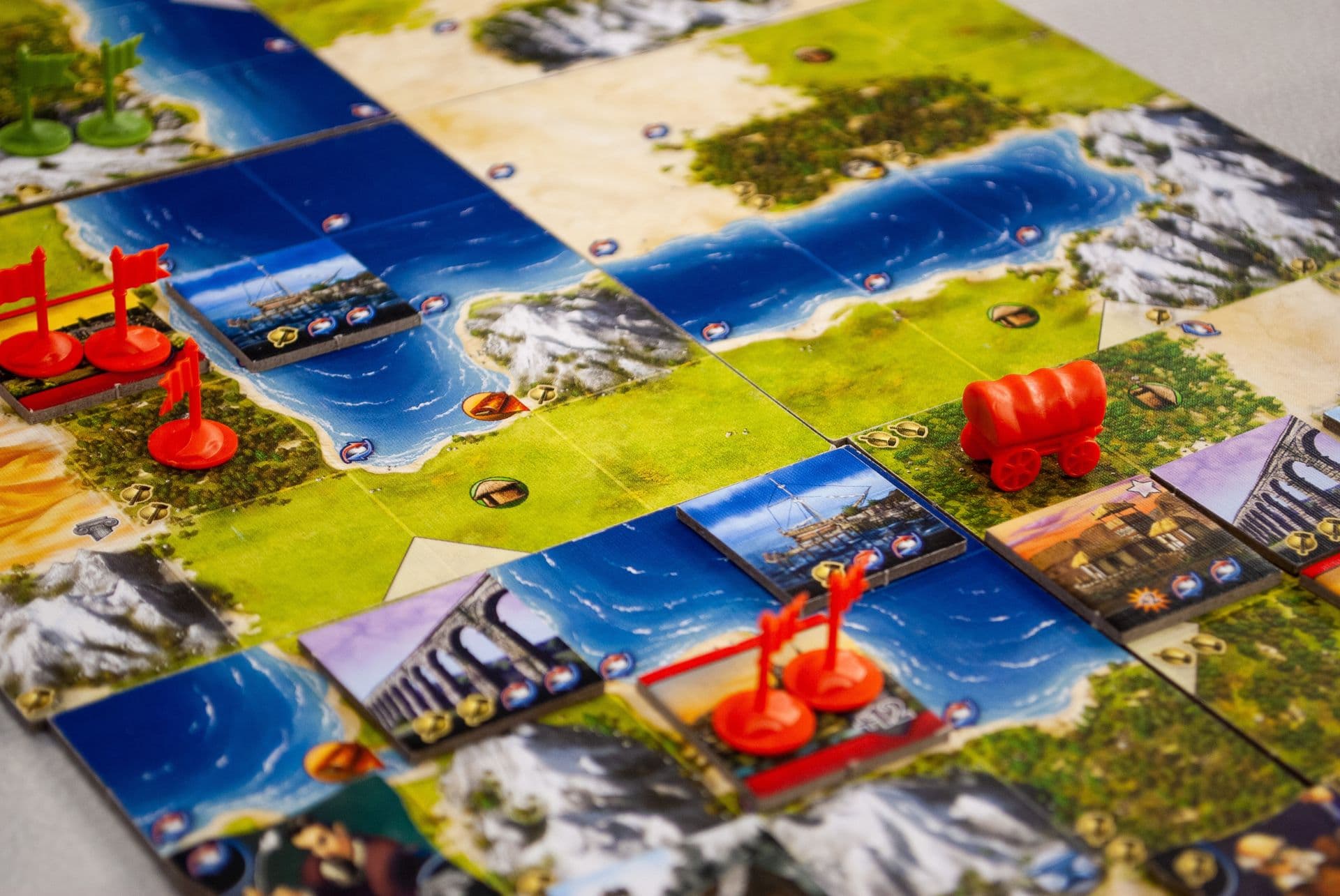 Board games spread across a table — dice, cards and colourful game pieces
